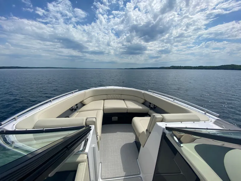 Slide: The Image of 2021 Regal 2800 Bowrider on calm water under a partly cloudy sky. - 7