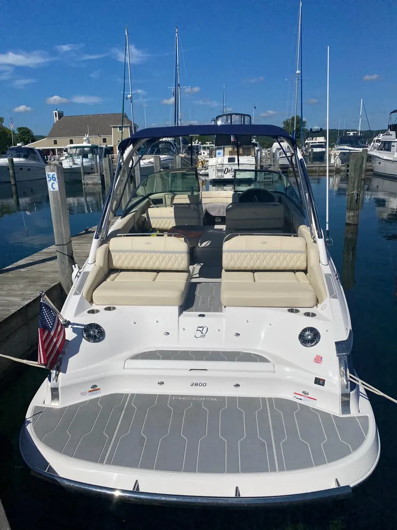 Slide: The Image of 2021 Regal 2800 Bowrider boat docked at marina, featuring spacious seating and sleek design. - 8