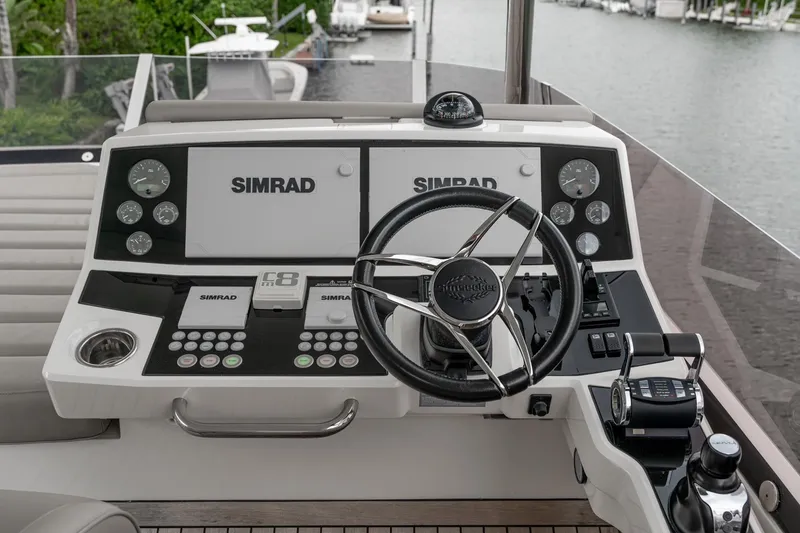 Slide: The Image of Luxurious Sunseeker Manhattan 66 yacht deck with seating, table, and waterfront view. - 26