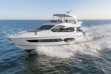 Slide: The Image of 2019 Sunseeker Manhattan 66 yacht cruising on open water. - 30