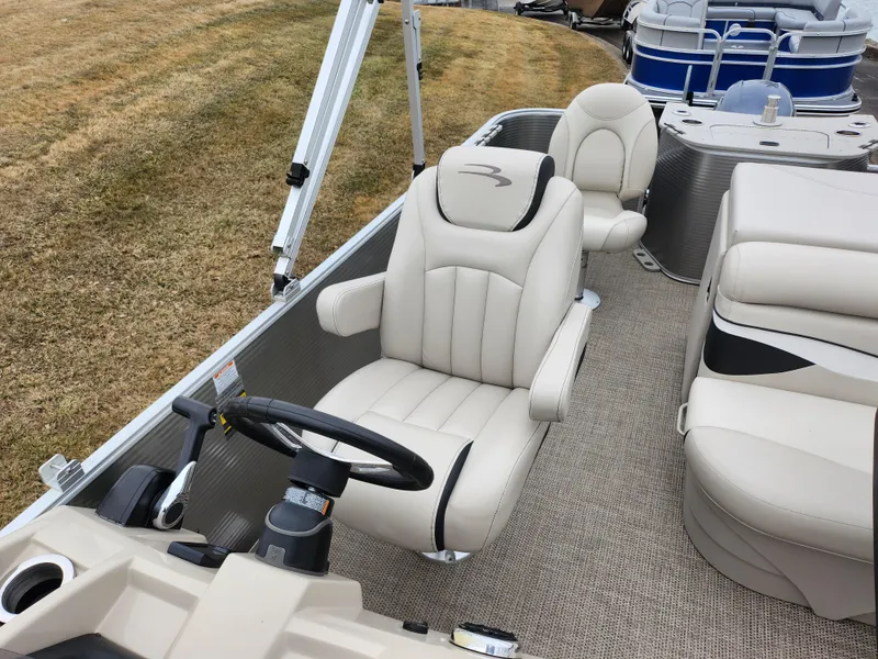 Slide: The Image of 2019 Bennington SX 22 Cruise and Fish boat interior with plush seating and steering wheel. - 13