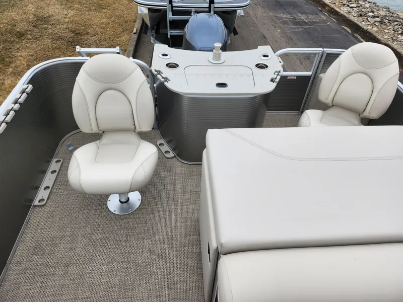 Slide: The Image of 2019 Bennington SX 22 Cruise and Fish boat interior with beige seating and fishing station. - 15
