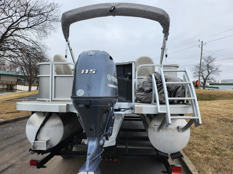 Slide: The Image of 2019 Bennington SX 22 Cruise and Fish pontoon boat with Yamaha 115 engine, parked on trailer. - 2
