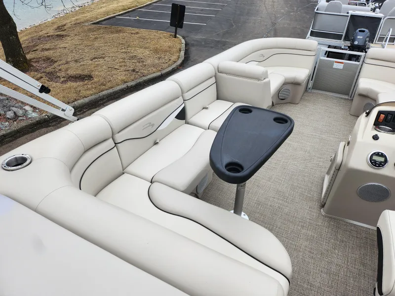 Slide: The Image of 2019 Bennington SX 22 Cruise and Fish boat interior with beige seating and table. - 22