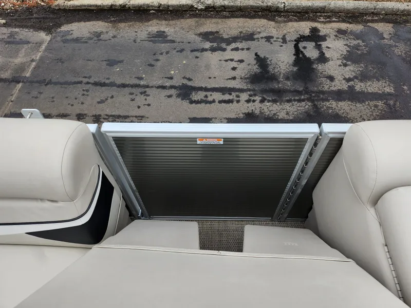 Slide: The Image of 2019 Bennington SX 22 Cruise and Fish boat interior with beige seating and metal gate. - 25