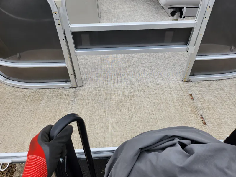 Slide: The Image of 2019 SunCatcher V16 Fish boat interior with beige flooring and seating area. - 10