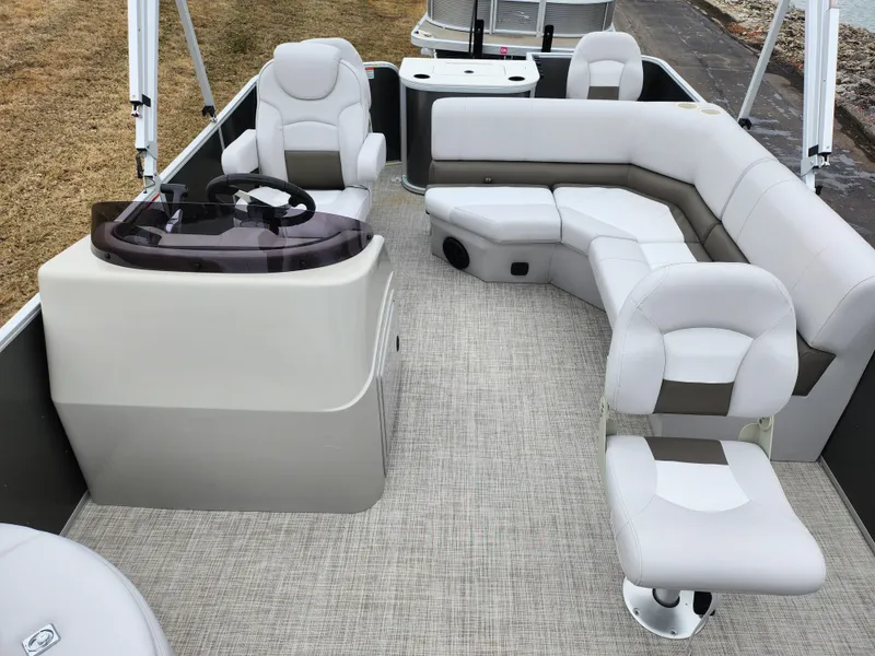 Slide: The Image of 2019 SunCatcher V16 Fish boat interior with plush seating and steering console. - 11