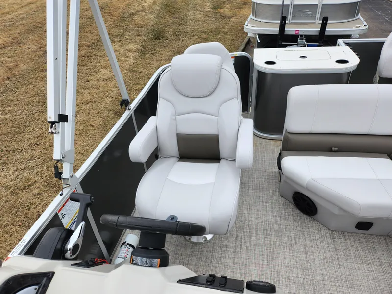 Slide: The Image of 2019 SunCatcher V16 Fish boat interior with white captain's chair and seating. - 13