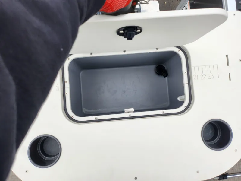 Slide: The Image of Open storage compartment on a 2019 SunCatcher V16 Fish boat. - 16