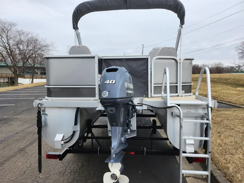Slide: The Image of 2019 SunCatcher V16 Fish pontoon boat with Yamaha 40HP engine, parked on trailer. - 2