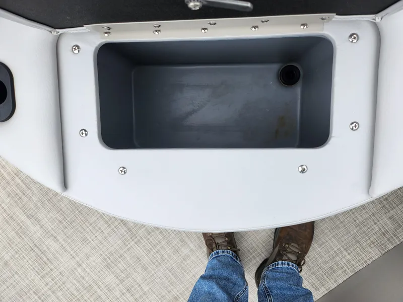 Slide: The Image of 2019 SunCatcher V16 Fish boat interior with storage compartment and person standing. - 24
