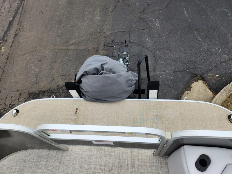 Slide: The Image of 2019 SunCatcher V16 Fish boat, rear view with covered motor, parked on asphalt. - 25