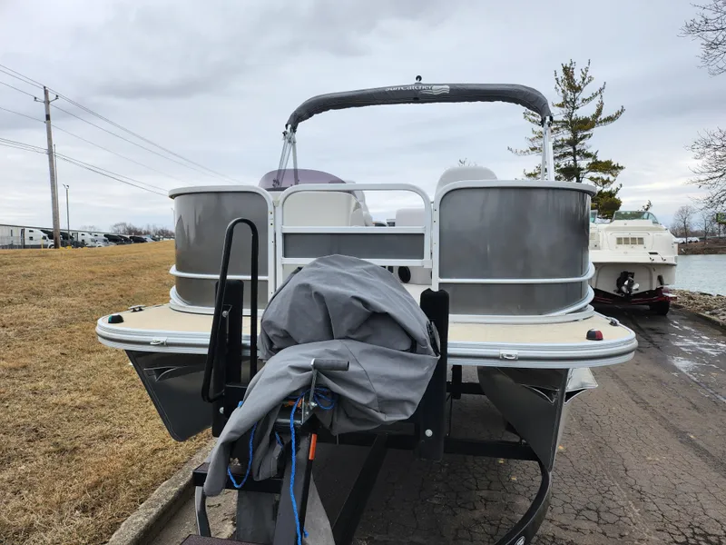 Slide: The Image of 2019 SunCatcher V16 Fish boat on trailer, parked near a lake. - 6