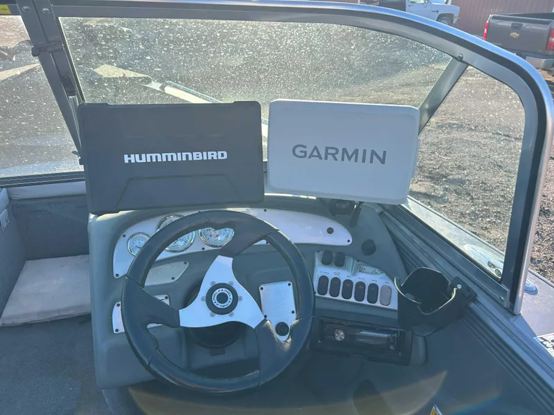 Slide: The Image of 2009 Lund 1950 Tyee Grand Sport dashboard with Humminbird and Garmin displays. - 7