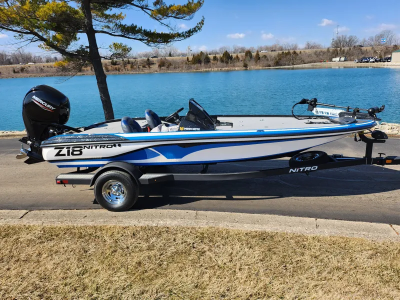 Slide: The Image of 2021 Nitro Z18 Pro boat parked by a scenic lake. - 10