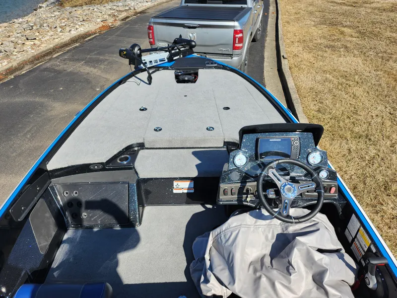 Slide: The Image of 2021 Nitro Z18 Pro boat interior with steering wheel and dashboard, parked near a truck. - 11