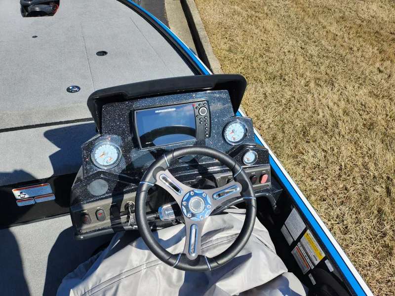 Slide: The Image of Steering console of a 2021 Nitro Z18 Pro boat with gauges and navigation display. - 12
