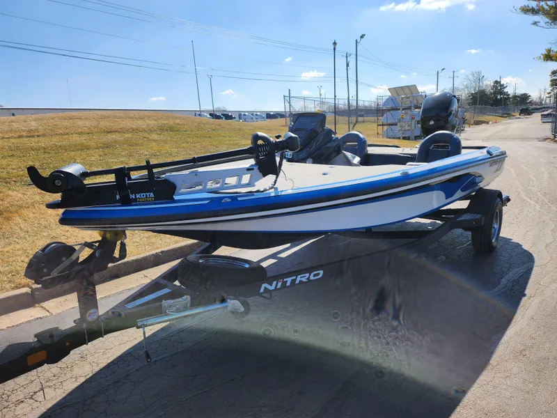Slide: The Image of 2021 Nitro Z18 Pro fishing boat on trailer, parked outdoors under clear sky. - 6