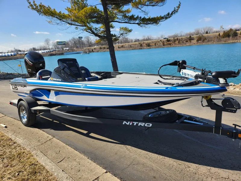 Slide: The Image of 2021 Nitro Z18 Pro boat on trailer by a lake, under clear blue sky. - 9