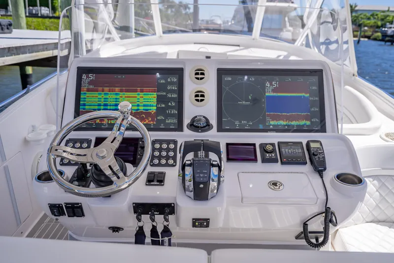 Slide: The Image of Intrepid 407 Cuddy 2020 boat dashboard with advanced navigation and control systems. - 13