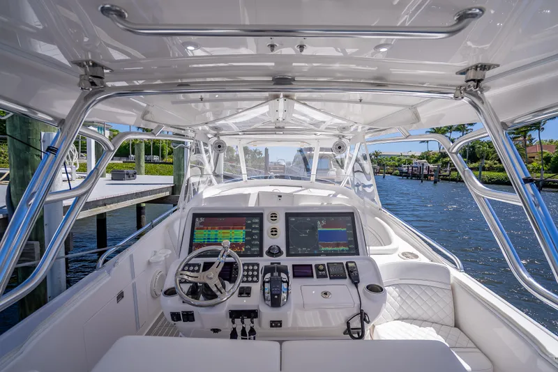 Slide: The Image of 2020 Intrepid 407 Cuddy boat cockpit with advanced navigation systems and luxurious seating. - 16