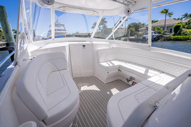 Slide: The Image of Luxurious interior of 2020 Intrepid 407 Cuddy boat with white seating and clear views. - 17