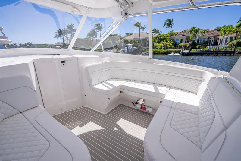 Slide: The Image of Luxurious interior of 2020 Intrepid 407 Cuddy boat with white seating and waterfront view. - 18