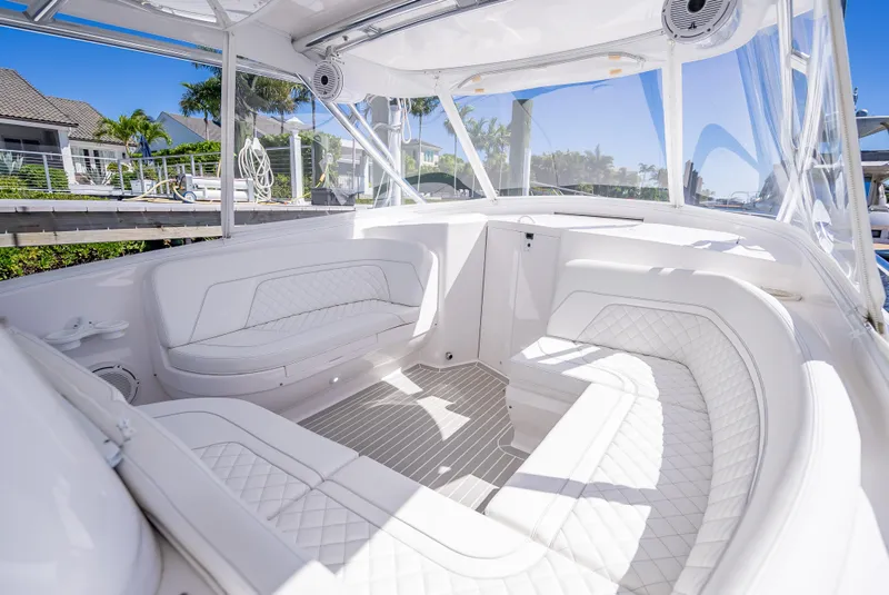 Slide: The Image of Luxurious interior of 2020 Intrepid 407 Cuddy boat with white seating and clear canopy. - 19