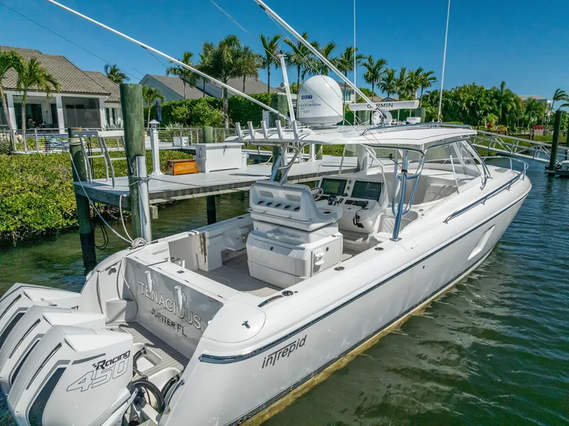 Slide: The Image of 2020 Intrepid 407 Cuddy boat docked in a scenic marina setting. - 3