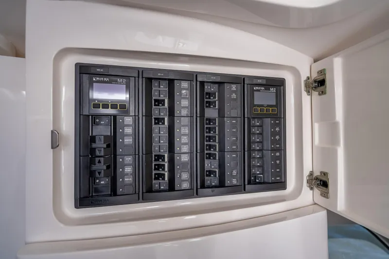 Slide: The Image of Electrical panel inside a 2020 Intrepid 407 Cuddy boat, featuring multiple switches and controls. - 30