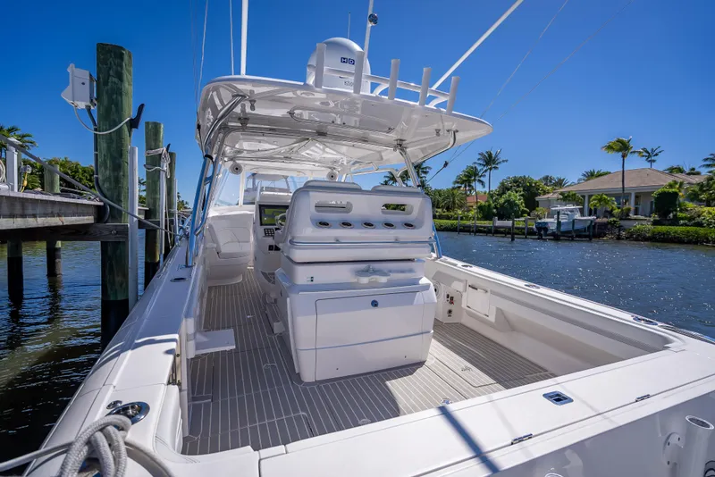 Slide: The Image of 2020 Intrepid 407 Cuddy boat docked by a scenic waterfront. - 35