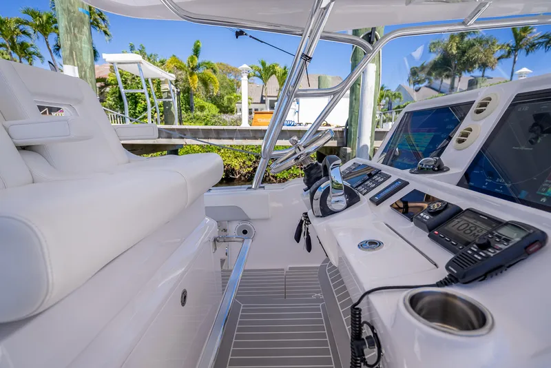 Slide: The Image of 2020 Intrepid 407 Cuddy boat cockpit with modern controls and seating. - 36