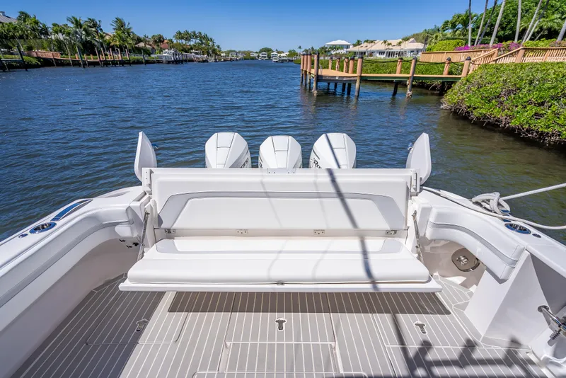 Slide: The Image of 2020 Intrepid 407 Cuddy boat with spacious deck and scenic waterfront view. - 37