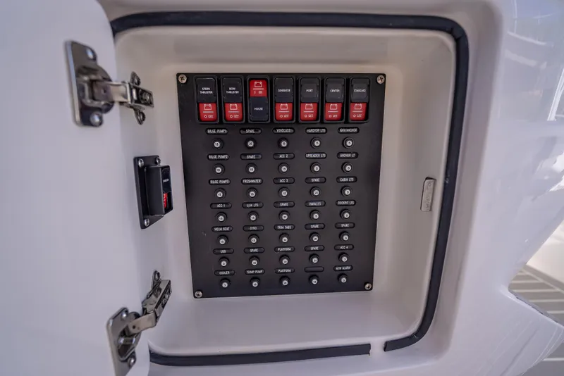 Slide: The Image of Control panel inside a 2020 Intrepid 407 Cuddy boat, featuring labeled switches. - 39