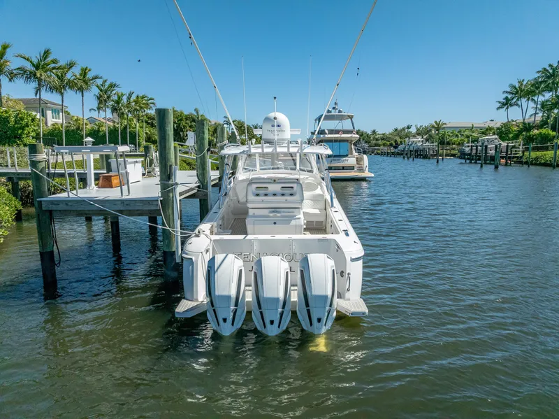 Slide: The Image of 2020 Intrepid 407 Cuddy boat docked in a scenic marina. - 4