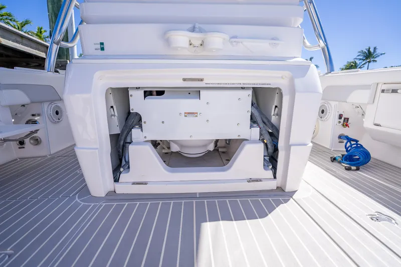 Slide: The Image of 2020 Intrepid 407 Cuddy boat interior with open storage compartment and deck view. - 40