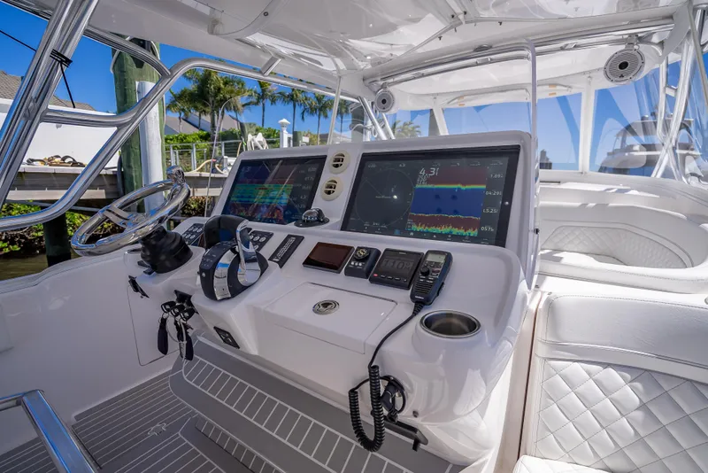 Slide: The Image of 2020 Intrepid 407 Cuddy boat cockpit with advanced navigation systems and luxurious seating. - 42