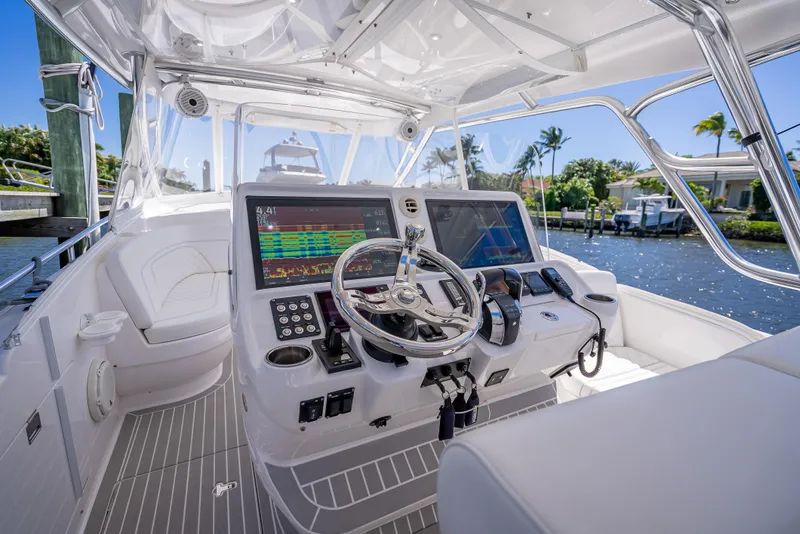 Slide: The Image of 2020 Intrepid 407 Cuddy boat cockpit with advanced navigation system and steering wheel. - 43