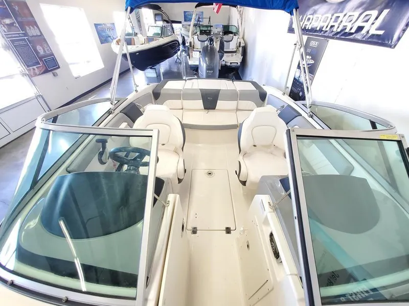 Slide: The Image of 2019 Chaparral 21 H2O OB Sport boat interior with seating and steering wheel. - 10
