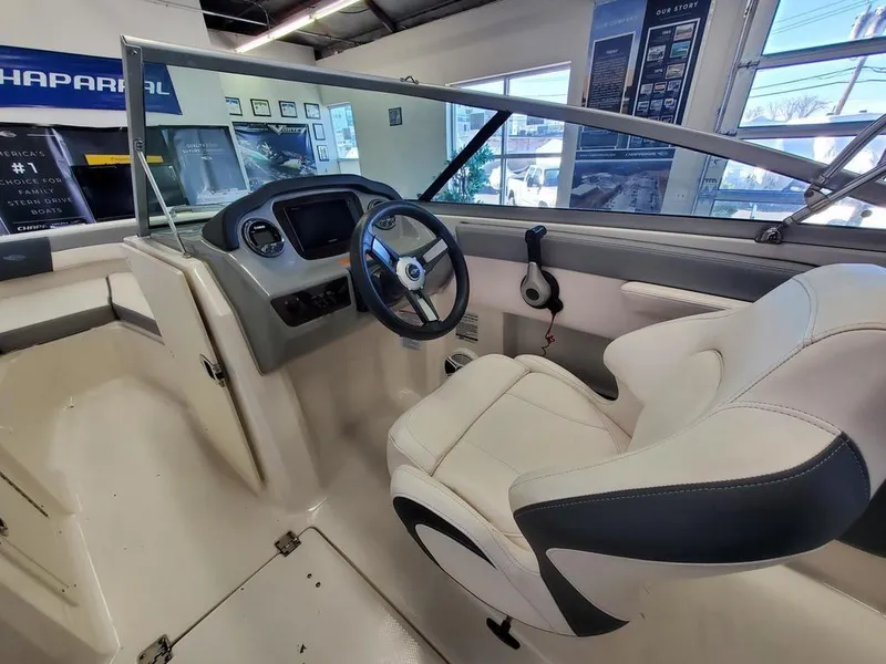 Slide: The Image of 2019 Chaparral 21 H2O OB Sport boat interior with steering wheel and captain's chair. - 7