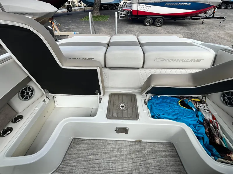 Slide: The Image of 2021 Crownline 220SS boat interior with open storage compartments and seating. - 11