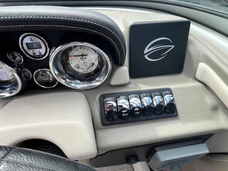 Slide: The Image of Dashboard of 2021 Crownline 220SS boat with gauges and control switches. - 12