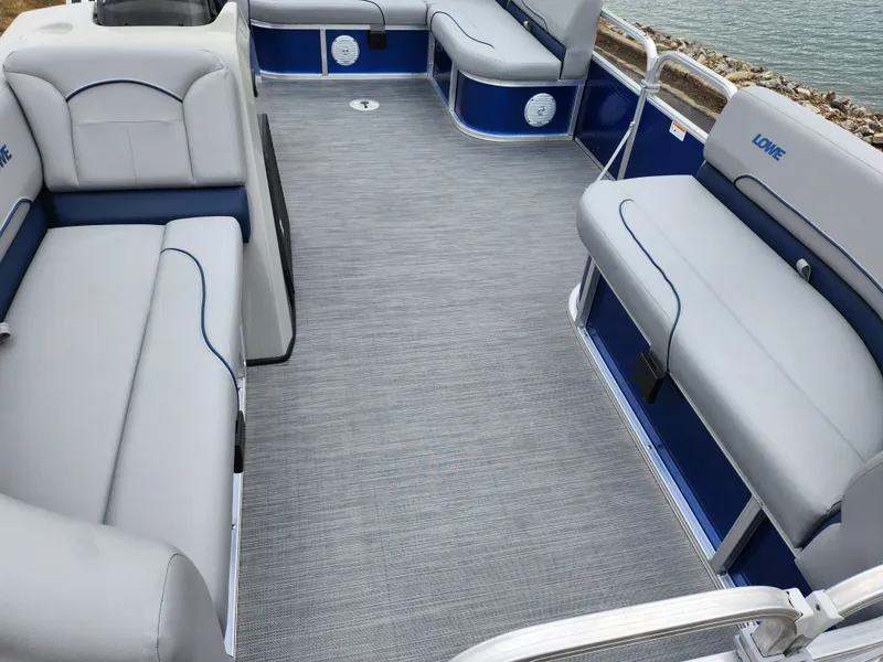 Slide: The Image of 2022 Lowe Ultra 160 Cruise pontoon boat interior with gray seating and blue accents. - 12