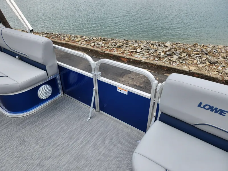 Slide: The Image of 2022 Lowe Ultra 160 Cruise pontoon boat interior with gray seating and blue accents. - 13