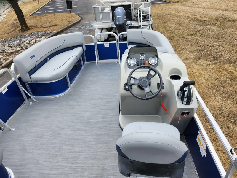 Slide: The Image of 2022 Lowe Ultra 160 Cruise pontoon boat interior with steering console and seating. - 18