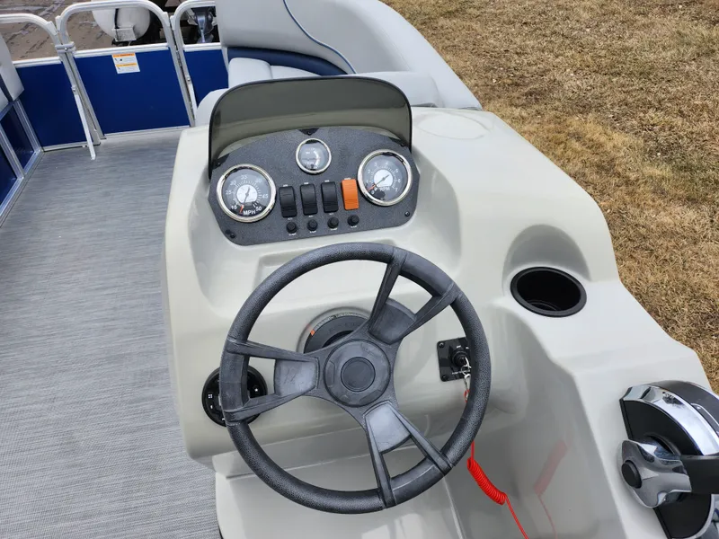 Slide: The Image of 2022 Lowe Ultra 160 Cruise boat dashboard with steering wheel and control panel. - 19