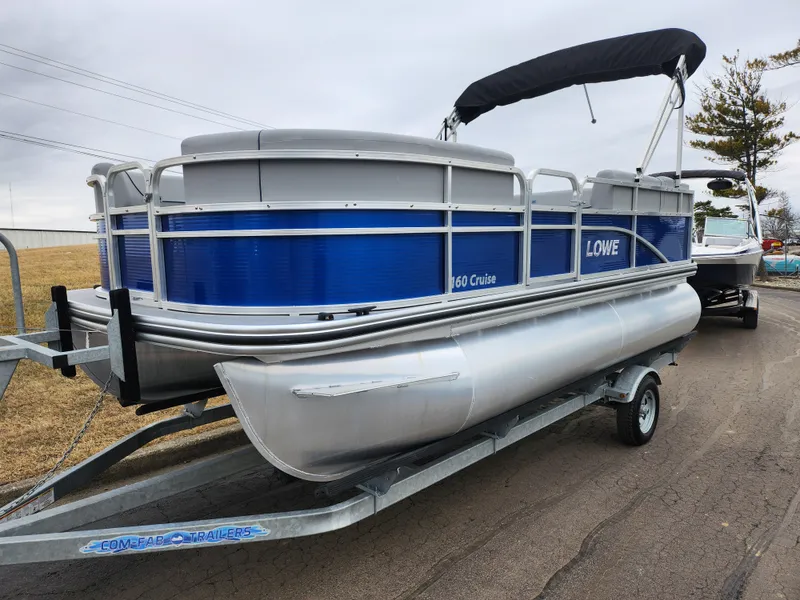 Slide: The Image of 2022 Lowe Ultra 160 Cruise pontoon boat on trailer, blue and silver design. - 5
