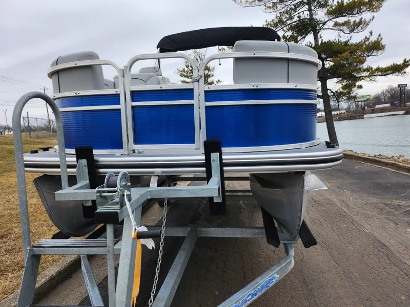 Slide: The Image of 2022 Lowe Ultra 160 Cruise pontoon boat on trailer by lakeside. - 6