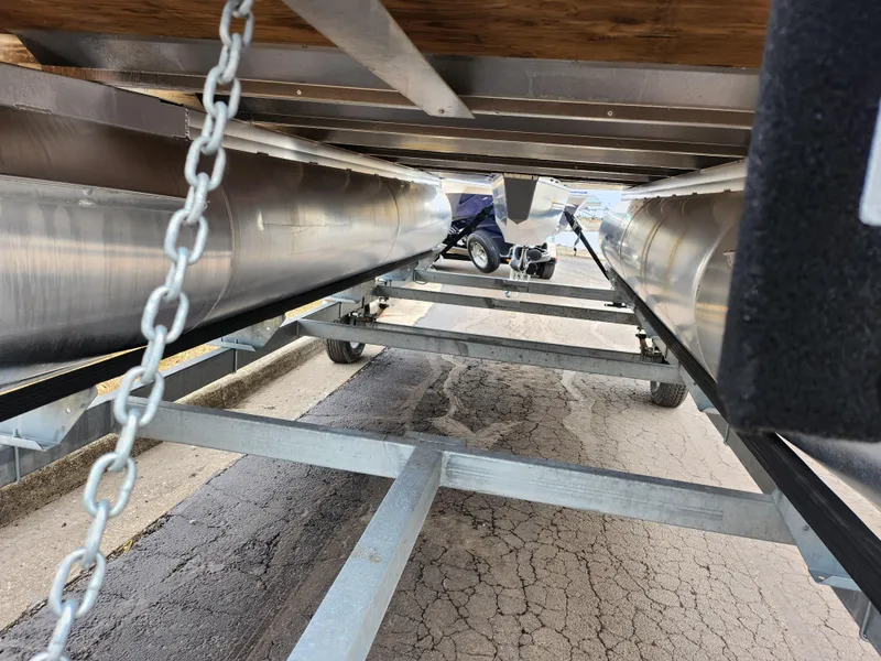 Slide: The Image of Underneath view of a 2022 Lowe Ultra 160 Cruise pontoon boat on a trailer. - 7