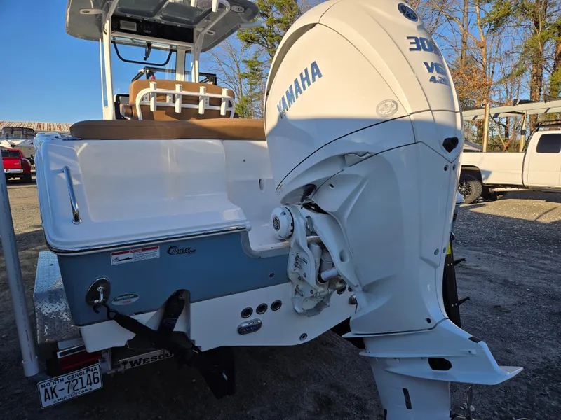 Slide: The Image of 2022 Sea Hunt Ultra 255 SE boat with Yamaha 300 outboard motor, parked outdoors. - 11